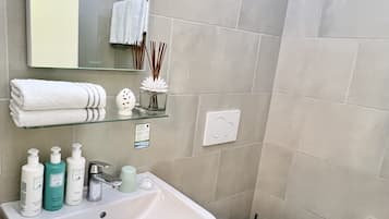Shower, hair dryer, towels, soap