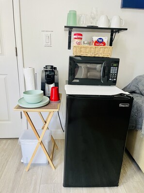 A compact kitchenette with a microwave, coffee maker, and a small refrigerator. - Large 2 Bedroom Suite with Secret Garden—5 min from downtown! (St. Petersburg)