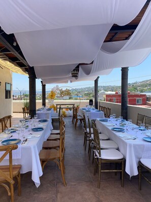 An outdoor dining area with white tablecloths, gold chairs, and a 'Nuestra Boda' sign. - Hotel La Lejona (San Miguel de Allende)