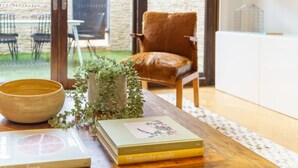 A wooden table with a bowl, a book titled '15 minute meals', and a potted plant. - Farrah - Designer, Three Bedroom Carlton Residence (Carlton)