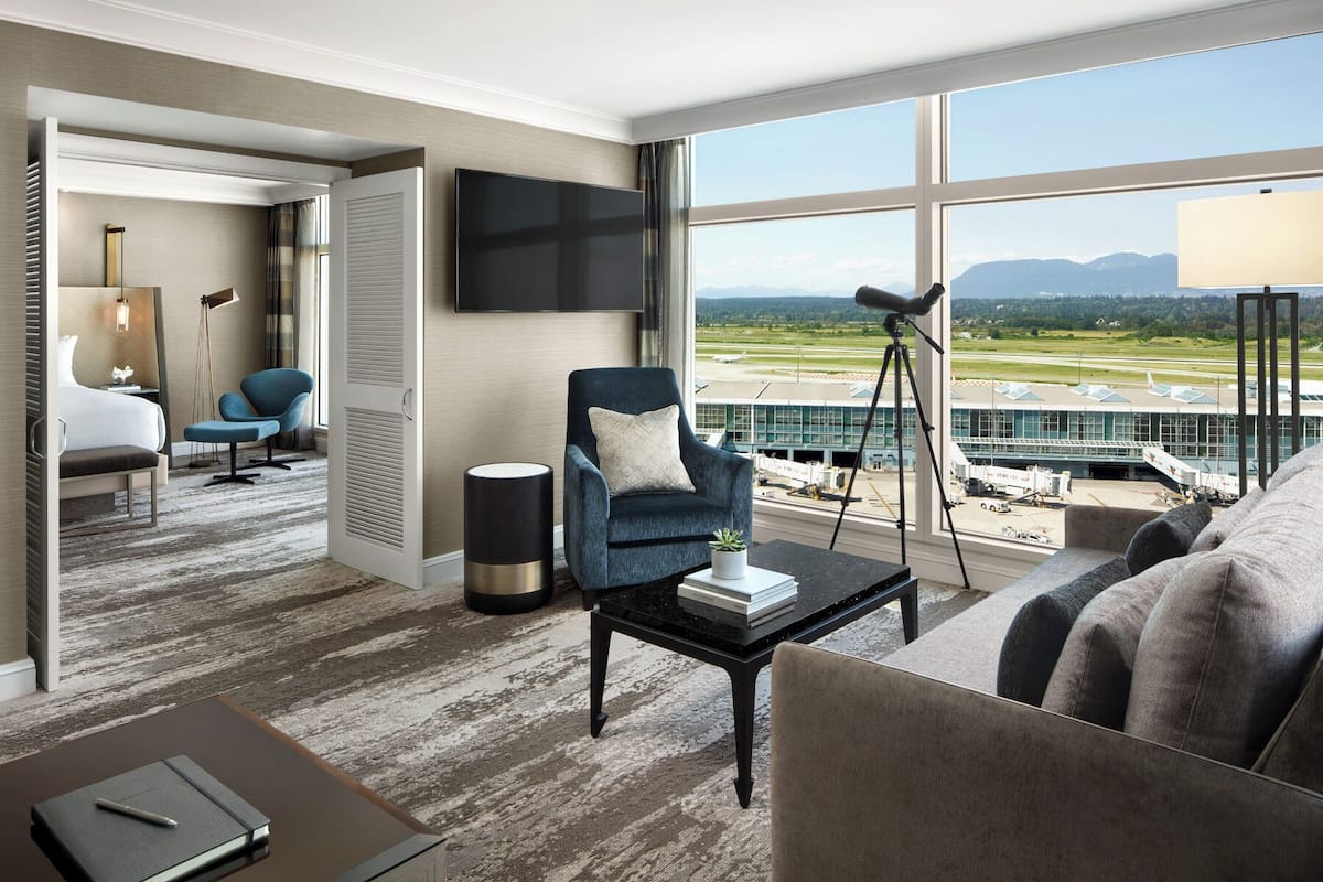 fairmont gold signature suite king runway view | living area | 55-inch lcd tv with cable channels, tv