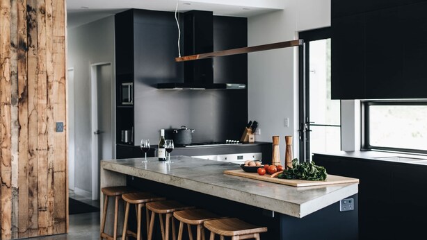 A modern kitchen with a large island, bar stools, a built-in oven, and a window providing natural light. - 'the sticks' - Sleeps 10, 5 Ensuites, Pool, Fire (Upper Kangaroo River)