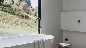 A modern bathroom with a freestanding bathtub, a wooden stool, and a wine glass. - 'the sticks' - Sleeps 10, 5 Ensuites, Pool, Fire (Upper Kangaroo River)