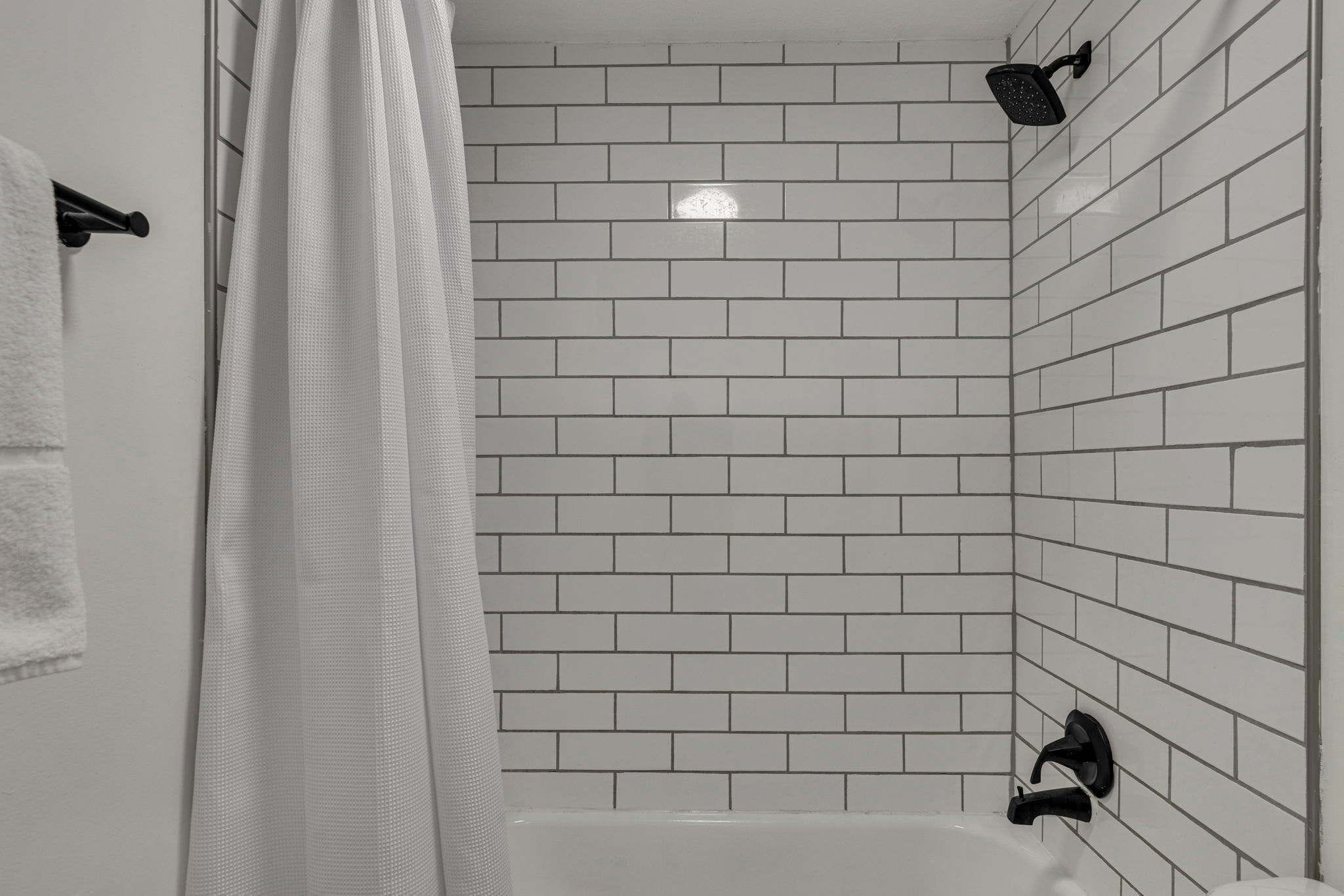 Bathtub, hair dryer, towels, shampoo