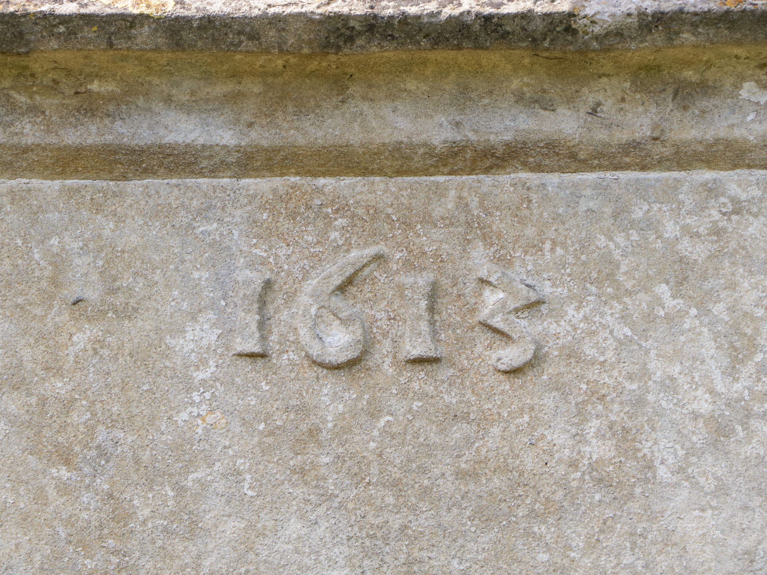 A stone surface with the year '1613' engraved.