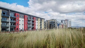 A modern apartment building with multiple balconies and a flat roof design. - Maritime Quarter  - 2 Bedroom Apartment - SA1 Beach Front (Fisherman's Way) (Swansea)