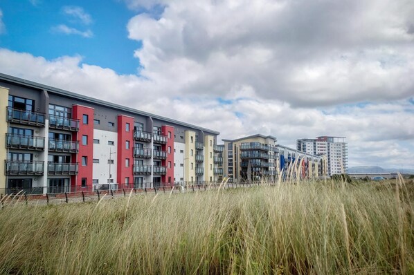 A modern apartment building with multiple balconies and a flat roof design. - Maritime Quarter - 2 Bedroom Apartment - SA1 Beach Front (Fisherman's Way) (Swansea)