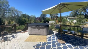 A wooden deck with a hot tub, a covered seating area, and a view of a residential neighborhood. - Gated Estate-Master Bedroom w/Full Bath with Private Spa (Redwood Valley)