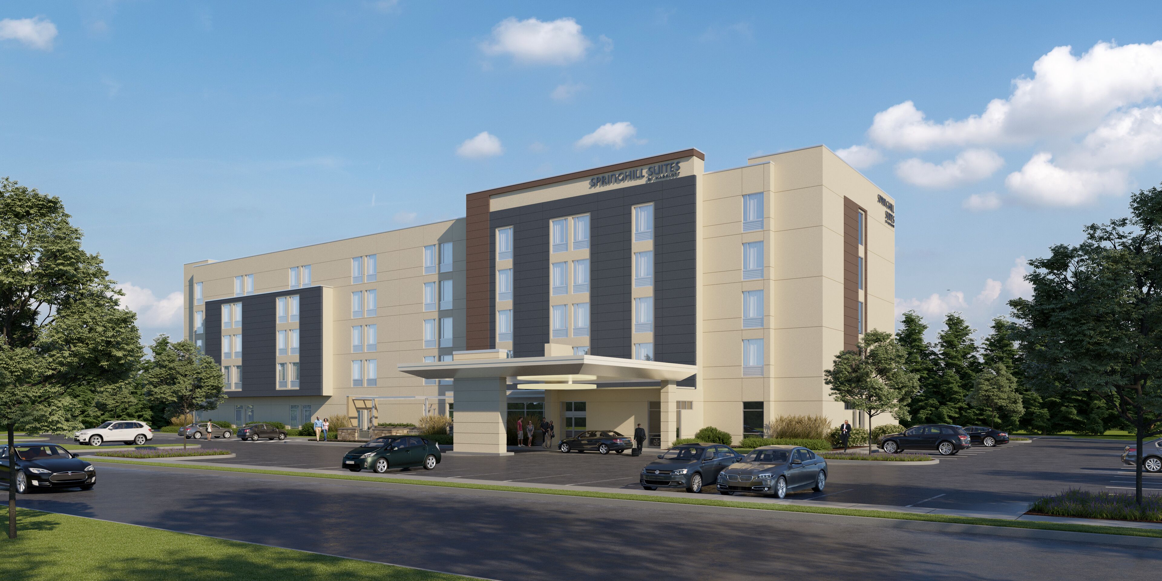 A modern hotel with a central entrance, multiple floors, and a parking lot with several cars.