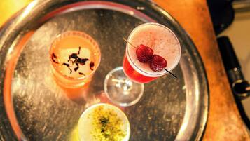 Three drinks on a metal tray.
