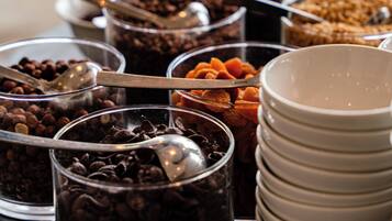 A buffet with various food items and serving utensils.