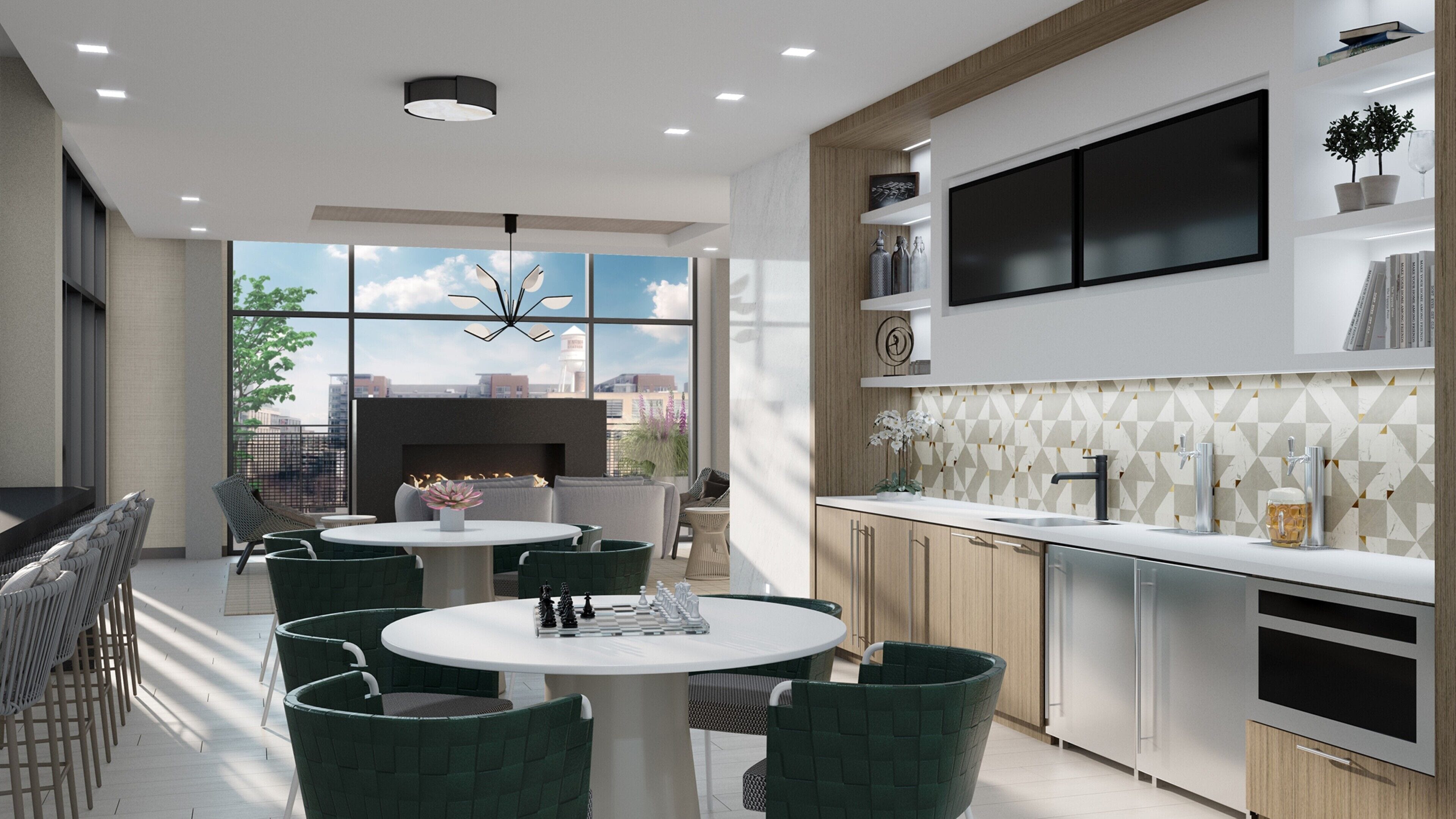 A modern kitchen with a built-in oven, a large window, and a dining area with green chairs and a round table.