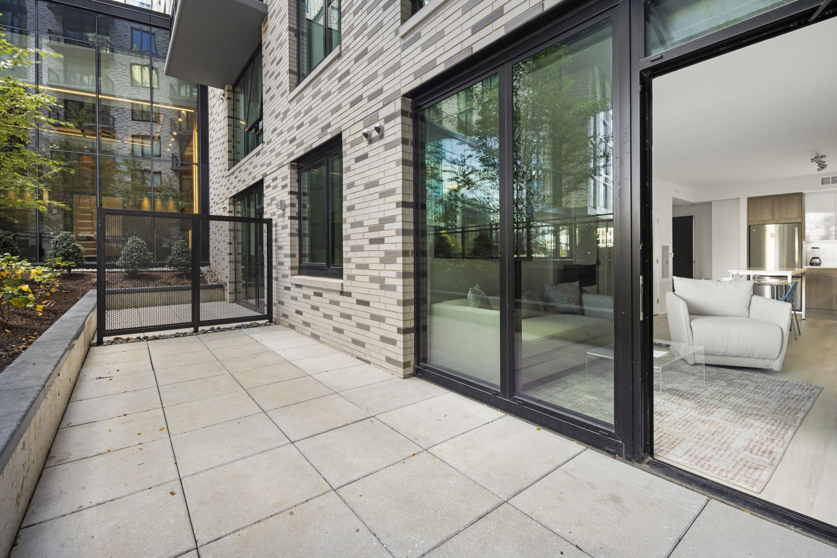 A modern building with large glass doors leading to a well-lit interior.