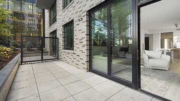 A modern building with large glass doors leading to a well-lit interior.
