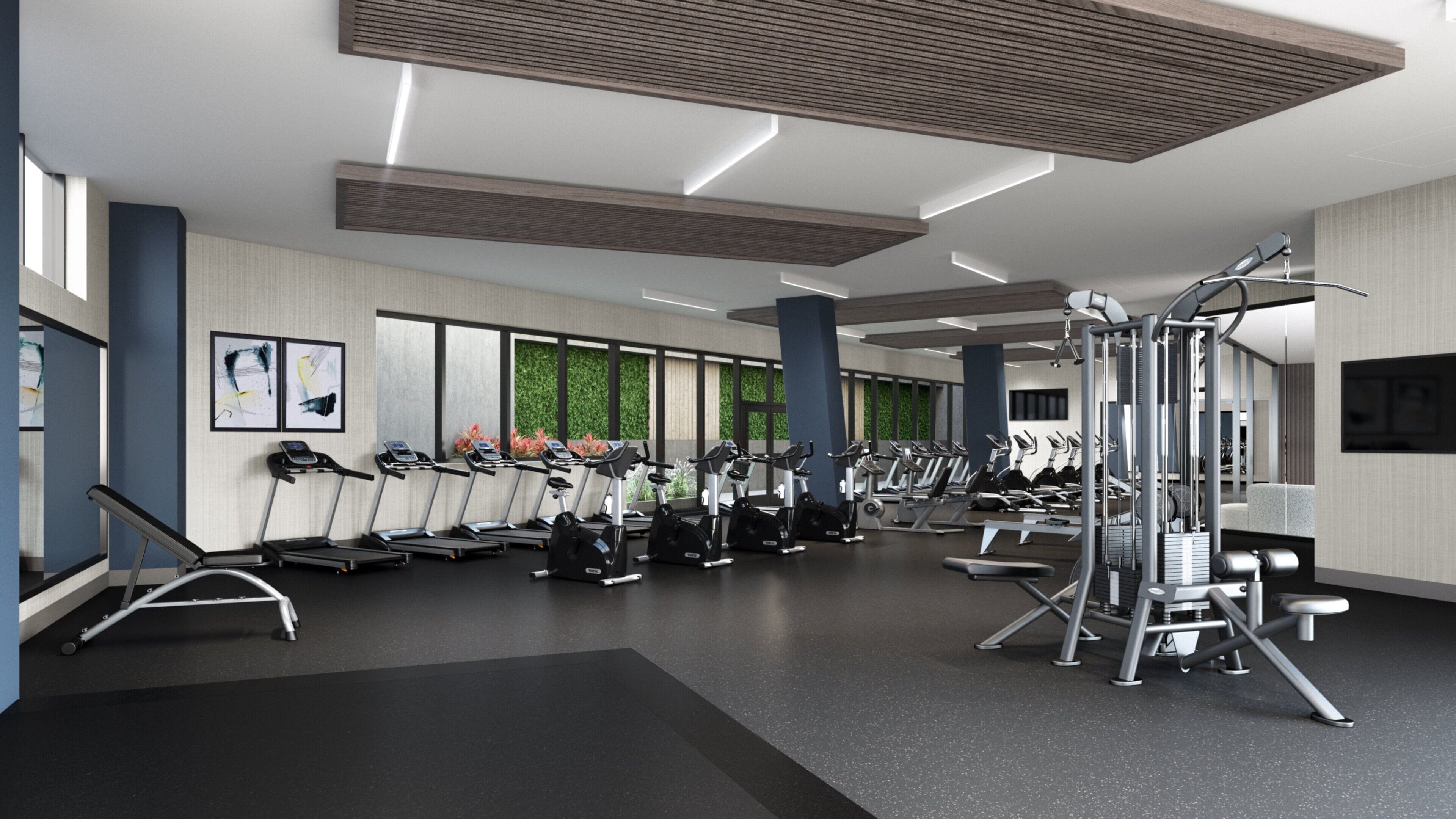 Una palestra moderna dotata di tapis roulant, ellittiche e macchinari per l'allenamento con i pesi.