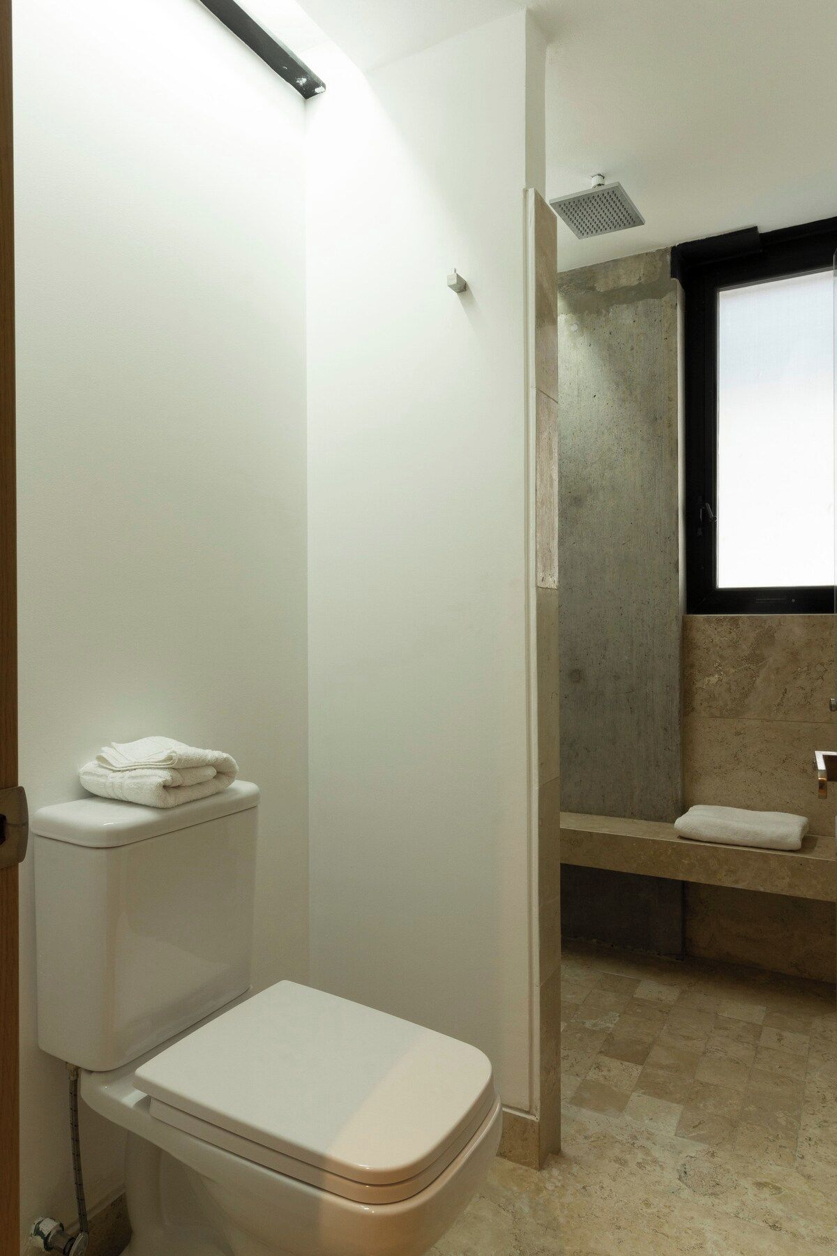 Une salle de bain avec des toilettes, une douche et un lavabo.