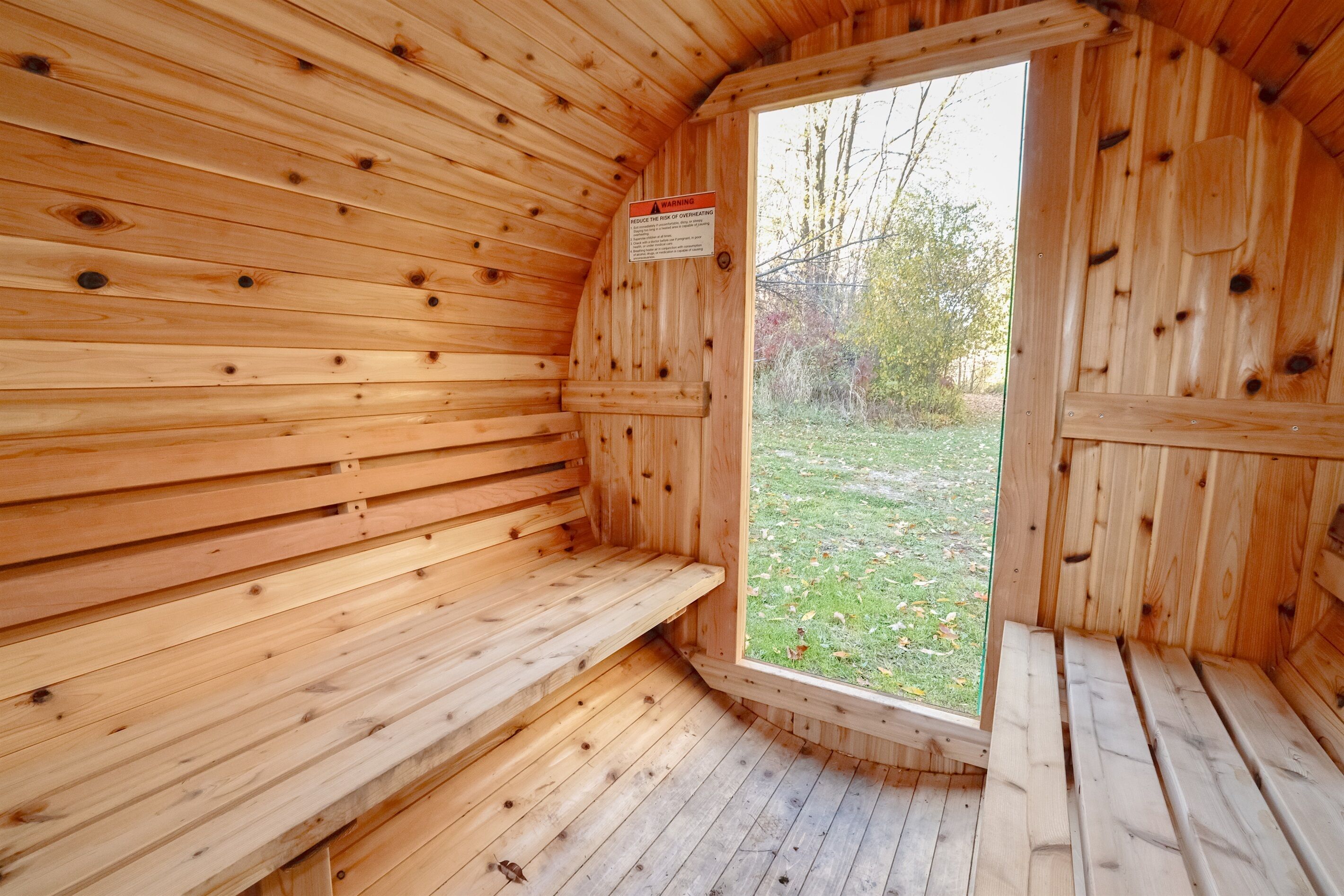 A sauna room with wooden walls and benches.