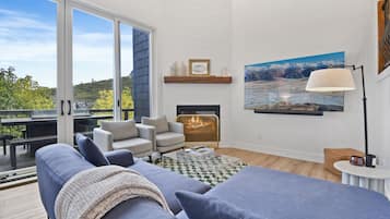 Deluxe Townhome | Living area | 60-inch flat-screen TV with cable channels, fireplace