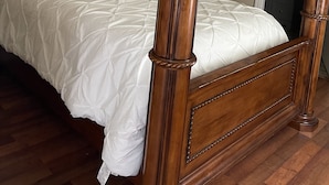 A four-poster bed with a wooden frame and white bedding. - We are located in the beautiful blue ridge mountains (Sparta)