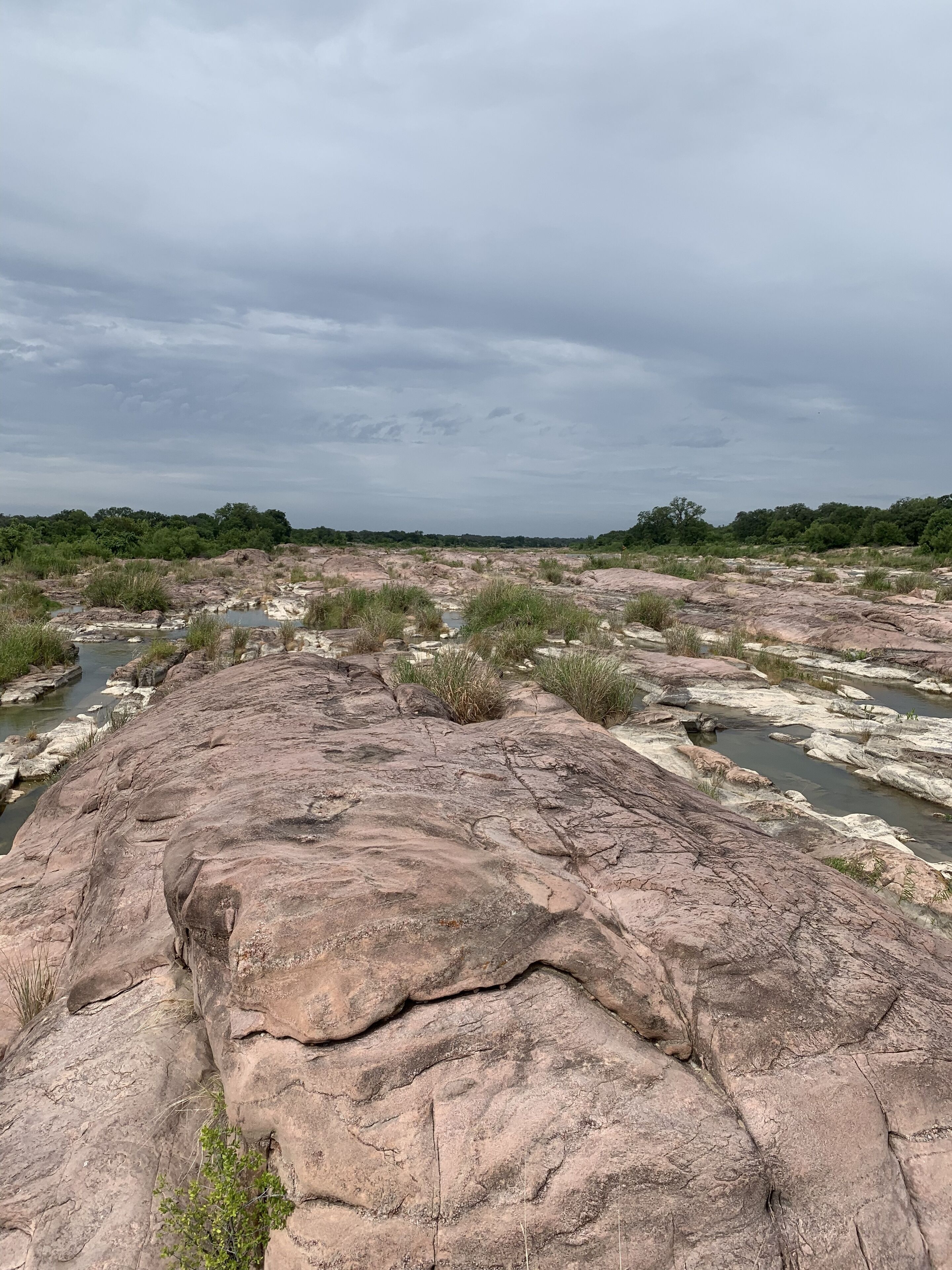 A rocky landscape with a river flowing through it.
