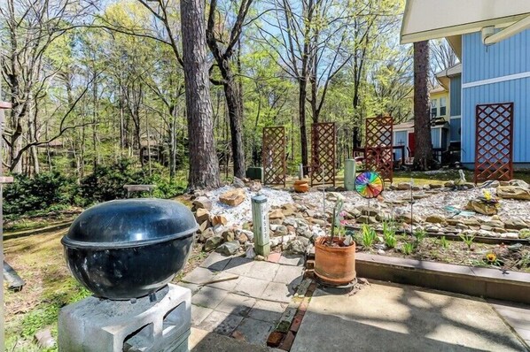 Relax in a serene garden setting surrounded by lush greenery and a variety of plants.