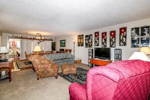 Relax in this inviting living room with a comfortable sofa set, armchairs, and a coffee table.