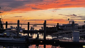 A marina at sunset with boats docked, a pier, and a clear sky. - Golf Cart to Beach, Pet Friendly, Fenced Yard, Amelia Island Quiet Home Escape (Fernandina Beach)