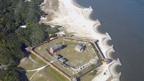 An aerial view of a fortified structure with a central building, surrounded by a moat and a beach. - Golf Cart to Beach, Pet Friendly, Fenced Yard, Amelia Island Quiet Home Escape (Fernandina Beach)