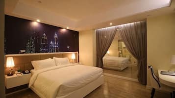 A hotel room with a large bed, bedside tables, a nightstand, a mirror, and a view of the cityscape.