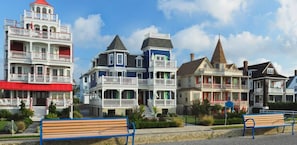 Coastal houses with diverse architectural styles offer outdoor spaces and public seating areas.