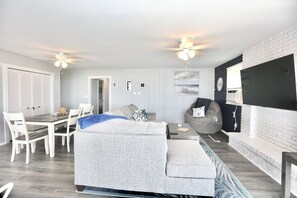 Relax in this stylish living space with a dining area, sofa, and flat-screen TV.