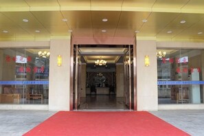 A hotel entrance with a red carpet, glass doors, and a chandelier. - Jing Chuan Hotel (Jing County)