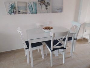 Enjoy meals in this stylish dining area with a glass-top table and comfortable seating.