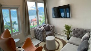 A modern living room with a large sofa, a coffee table, and a unique ceiling light fixture.