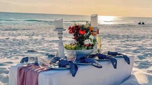 A table set on a beach with a view of the ocean. - FREE DAILY BEACH SERVICE!!!, GULFVIEW,GROUND FLOOR (Miramar Beach)