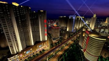 A high-rise hotel with multiple floors, a prominent entrance, and a surrounding urban landscape.