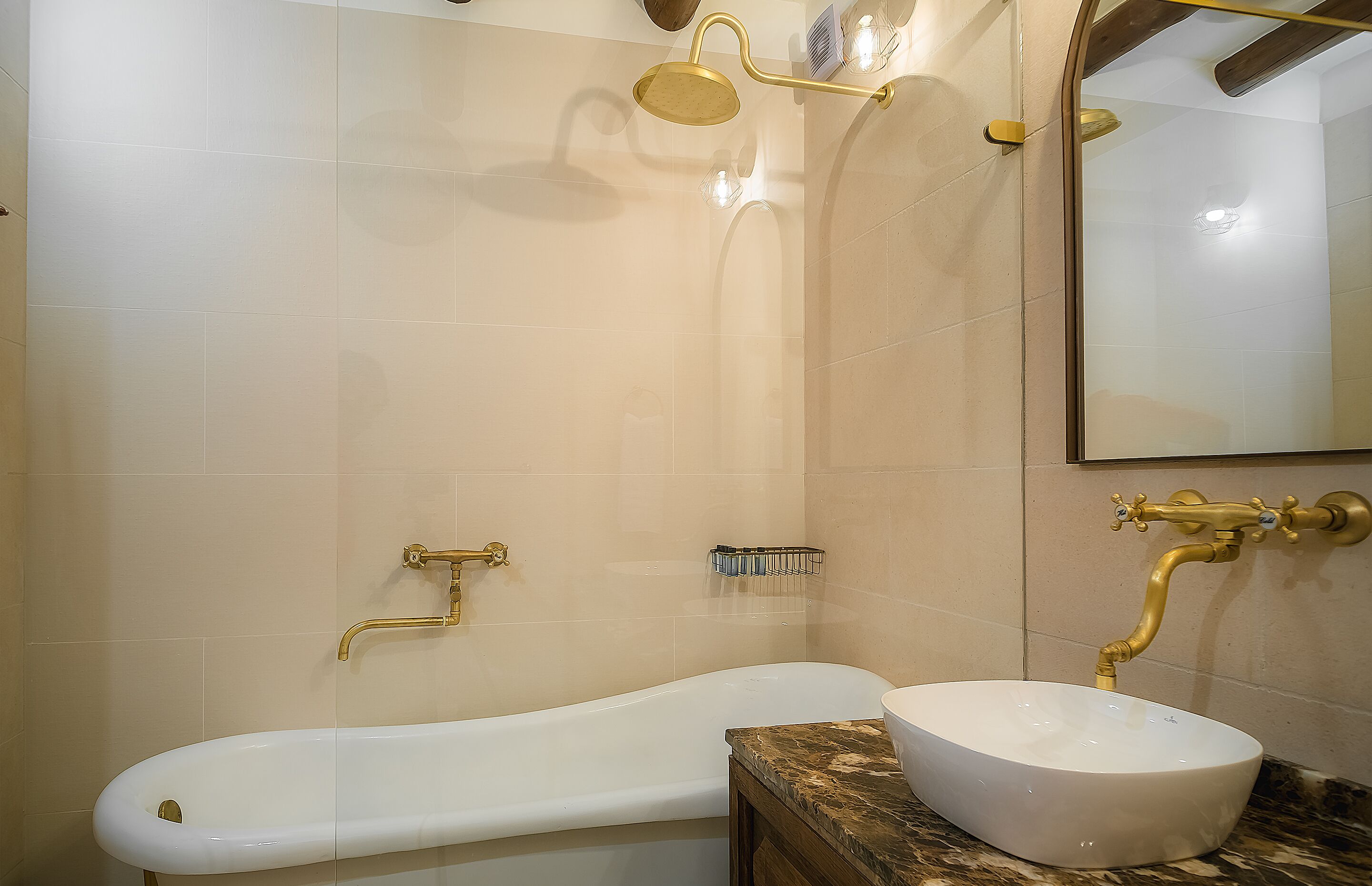 A bathroom with a freestanding bathtub, a vessel sink, and a shower with a handheld showerhead.