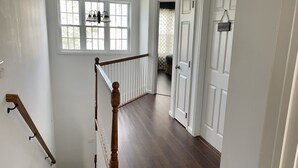 A staircase with a wooden handrail leading to a landing. - Home away from home! Entire townhome- large backyard. Close to many colleges.  (Troy)