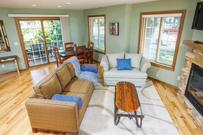 A living room with a sofa, a coffee table, and a fireplace.