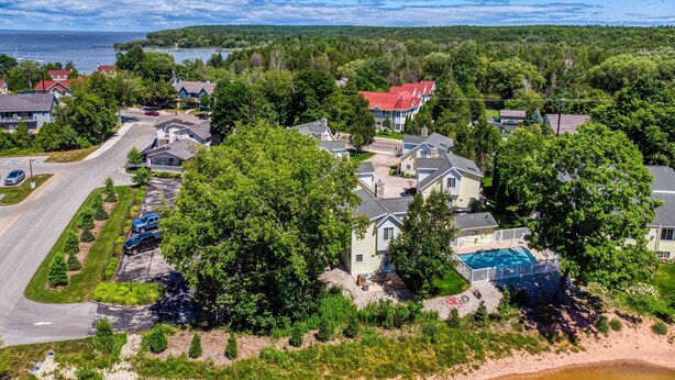 A residential area with houses, a parking lot, and a body of water. - Downtown Fish Creek, Sleeps 6 - Yellow Birch Cottage (Fish Creek)