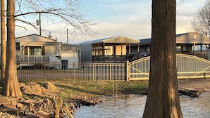 A residential area with houses, a gated entrance, and a small stream. - Come and relax at the Refuge at beautiful Reelfoot Lake! (Hornbeak)