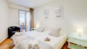A hotel room with two beds, a chair, a nightstand, and a balcony. - Au Vieux Port Cannes City Center, Cannes, France (Cannes)