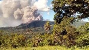 A volcano with smoke and ash clouds. - Red lava show lodge (Tanna Island)
