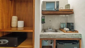 A compact kitchen with a microwave, sink, and coffee maker on a countertop. - Terasu Riviera Maya Hotel & Spa Luxury Edition, en Xcaret (Playa del Carmen)