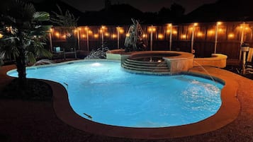 Relax by the pool surrounded by a tranquil atmosphere and lush greenery.