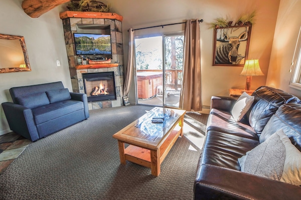 Living Room with Gas Fireplace and Sliders to Deck