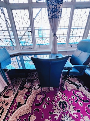 A room with a curved window, a patterned rug, and two blue chairs. - Entire 2beds flat/quiet/near Heathrow /3mins walk to Thames/Victorian/fireplace (Twickenham)