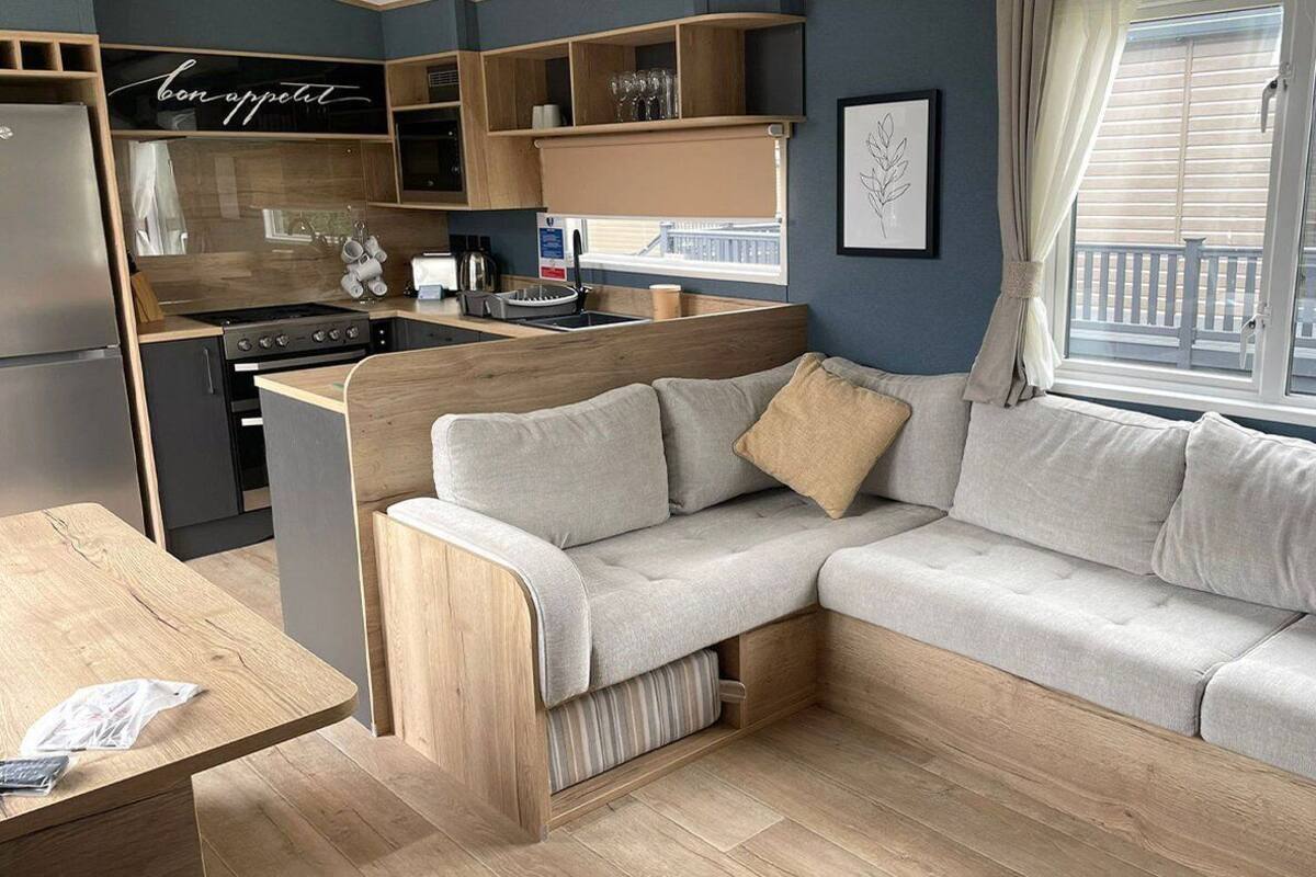 A compact living space with a kitchenette, a sofa, and a dining area.