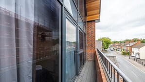A modern building with large windows, a brick facade, and a wooden ceiling. - Stunning 2-bed Apartment in Camberley (Camberley)