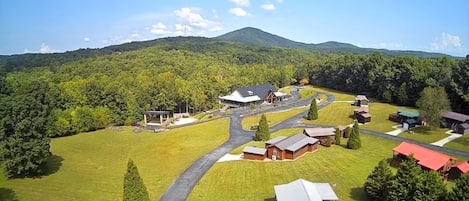 A rural property with a main building, several smaller structures, and a winding road.